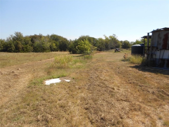 view of yard with a rural view