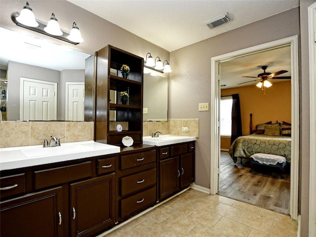 bathroom with tile patterned floors, decorative backsplash, ceiling fan, and vanity