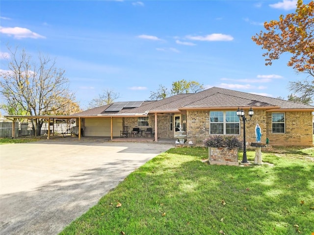 ranch-style home with a carport and a front lawn