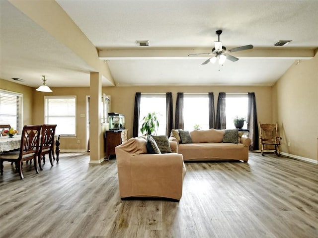 living room with lofted ceiling with beams, ceiling fan, and wood-type flooring