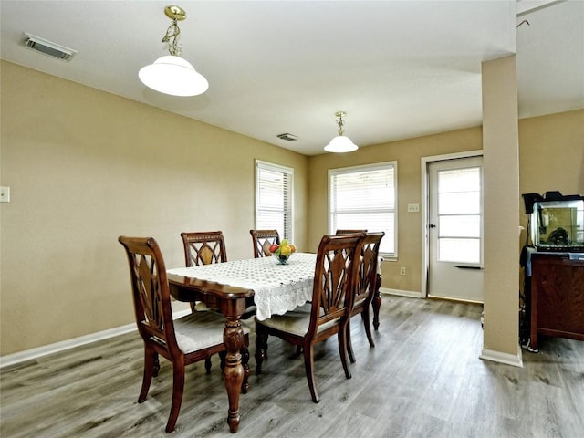 dining space with hardwood / wood-style floors