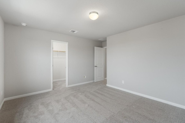 unfurnished room featuring light carpet