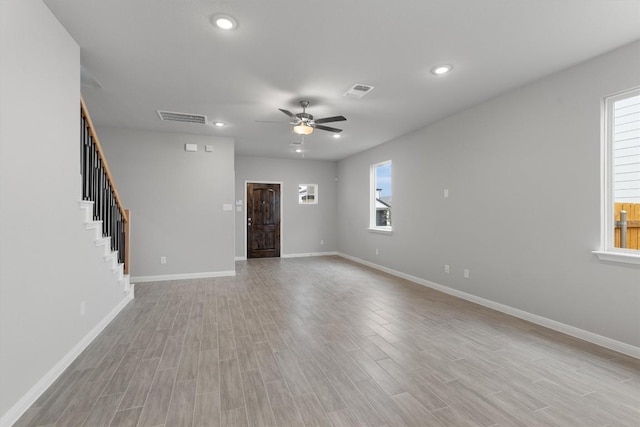 unfurnished room with plenty of natural light, ceiling fan, and light hardwood / wood-style flooring