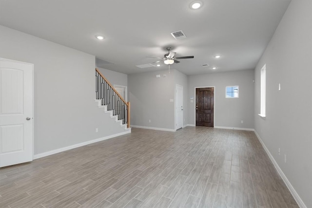 unfurnished living room with ceiling fan and light wood-type flooring