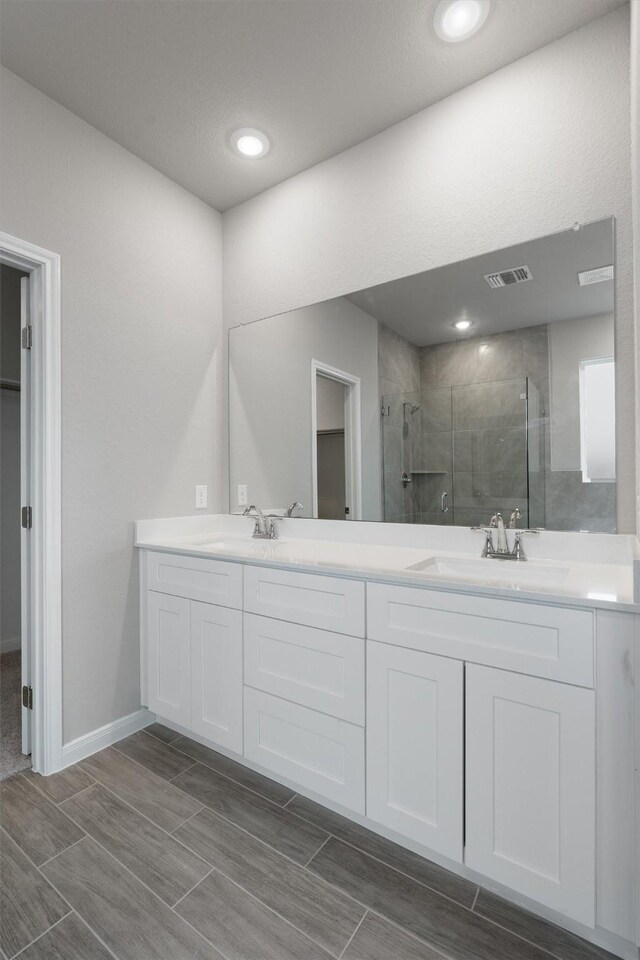 bathroom with vanity and an enclosed shower