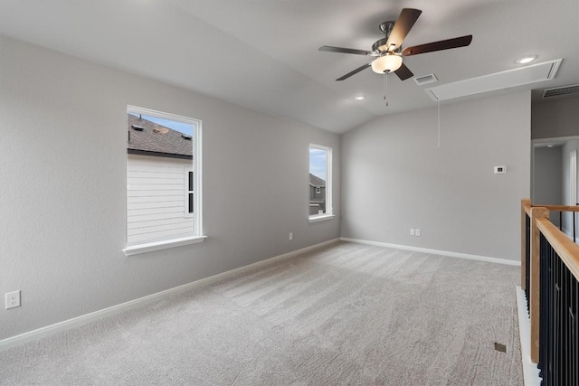 spare room with carpet flooring, ceiling fan, and vaulted ceiling