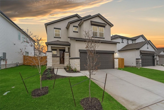 view of front of home with a garage and a lawn