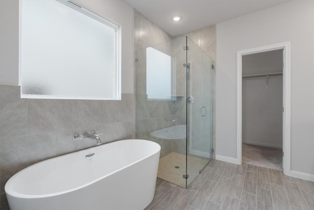 bathroom featuring shower with separate bathtub