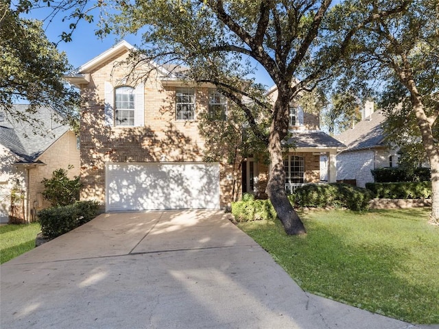 view of front facade featuring a front yard, brick siding, concrete driveway, and an attached garage