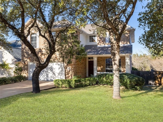 view of front of property featuring brick siding, fence, roof with shingles, a front yard, and driveway