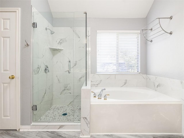 full bathroom featuring a bath and a stall shower