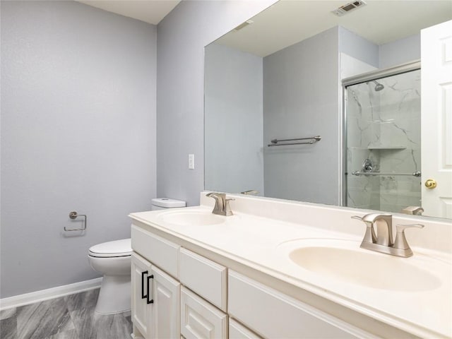 bathroom featuring a sink, visible vents, toilet, and a stall shower