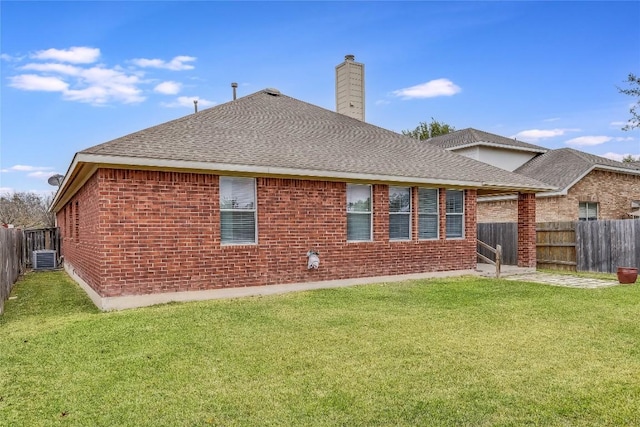 back of property featuring a lawn and central AC