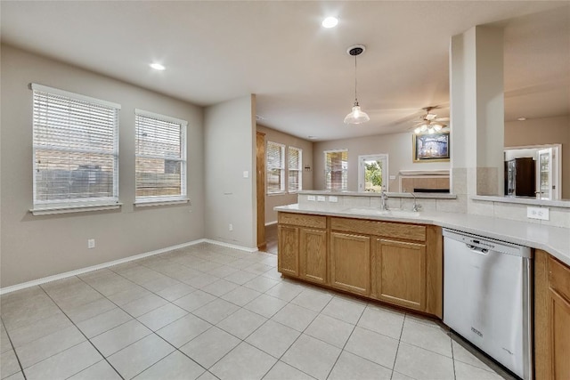 kitchen featuring ceiling fan, dishwasher, sink, decorative light fixtures, and light tile patterned floors