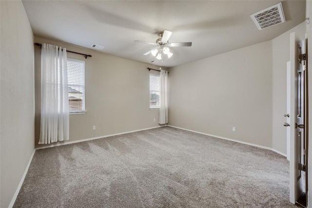 carpeted spare room with ceiling fan