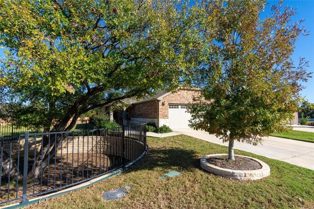 view of front of property with a front yard and a garage