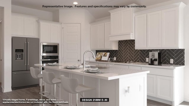 kitchen with a center island with sink, sink, white cabinetry, and stainless steel appliances