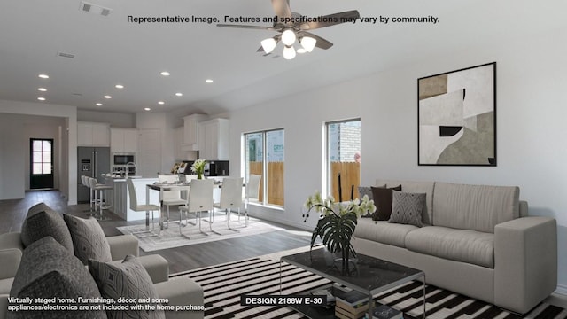 living room featuring a wealth of natural light, ceiling fan, and hardwood / wood-style flooring