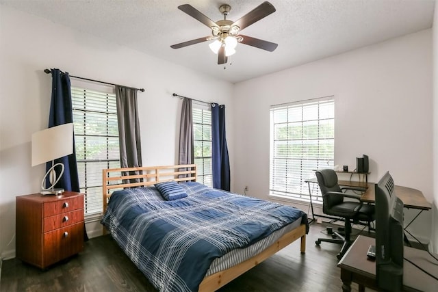 bedroom featuring a textured ceiling, dark hardwood / wood-style floors, and ceiling fan