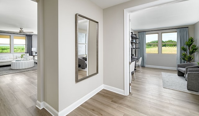 corridor with light hardwood / wood-style flooring