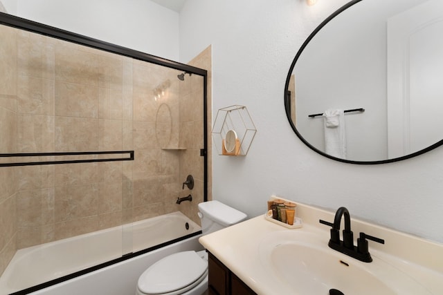 full bathroom with vanity, shower / bath combination with glass door, and toilet