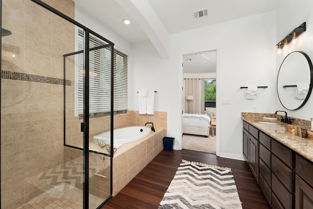 bathroom with vanity, separate shower and tub, and hardwood / wood-style floors