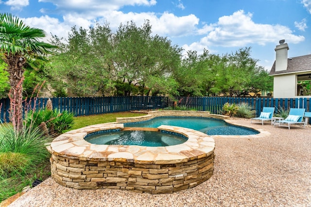 view of pool featuring an in ground hot tub and a patio