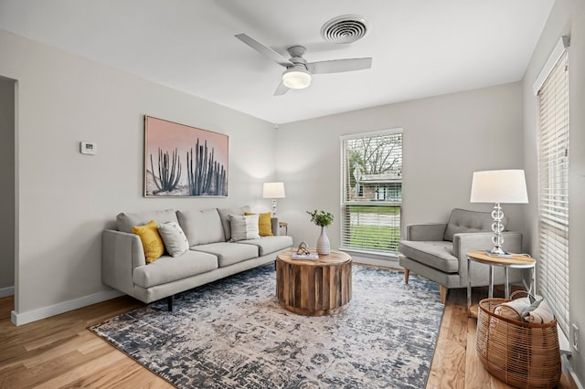 living room with hardwood / wood-style flooring and ceiling fan