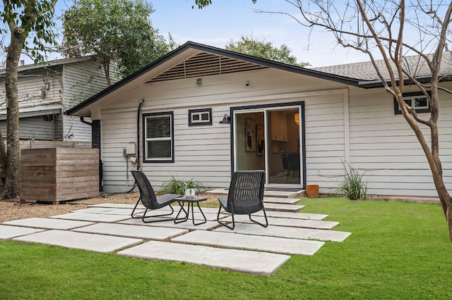 back of property featuring a patio area and a yard