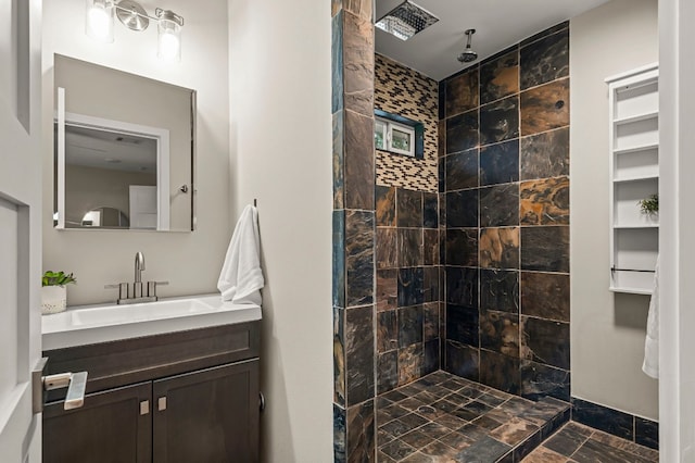 bathroom with vanity and tiled shower