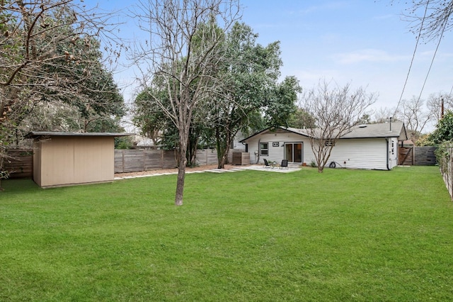 view of yard featuring a shed and a patio