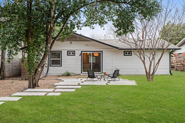 back of house with a yard and a patio area