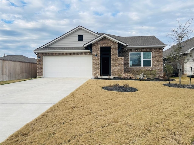 view of front of house featuring a garage and a front yard