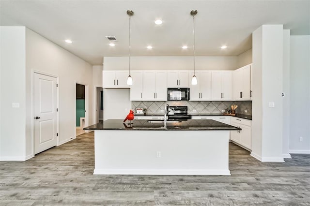 kitchen with white cabinetry, sink, pendant lighting, a kitchen island with sink, and black appliances