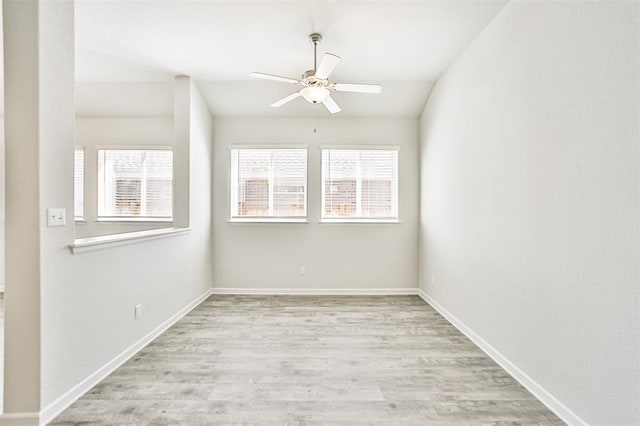 unfurnished room with ceiling fan, light hardwood / wood-style flooring, and lofted ceiling