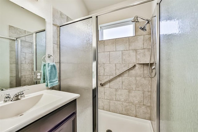 bathroom featuring vanity and an enclosed shower