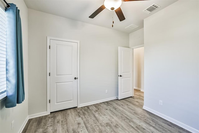 unfurnished bedroom featuring light wood-type flooring and ceiling fan