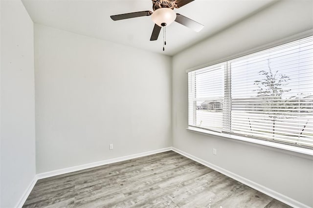 spare room featuring ceiling fan and light hardwood / wood-style floors