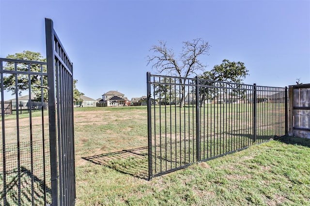 view of gate featuring a lawn