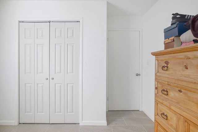 tiled bedroom featuring a closet