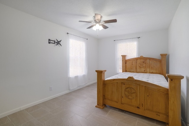 bedroom with multiple windows and ceiling fan