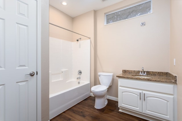 full bathroom featuring toilet, vanity, hardwood / wood-style floors, and bathing tub / shower combination