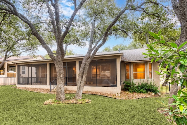 120 Ruellia Dr, Georgetown, TX 78633 - rear view of house with stucco siding, a sunroom, fence, and a yard