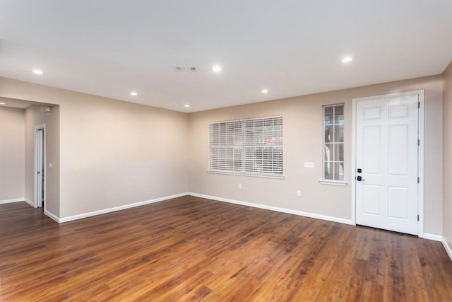 spare room featuring dark wood-type flooring