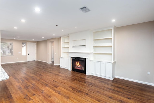 unfurnished living room with dark hardwood / wood-style floors