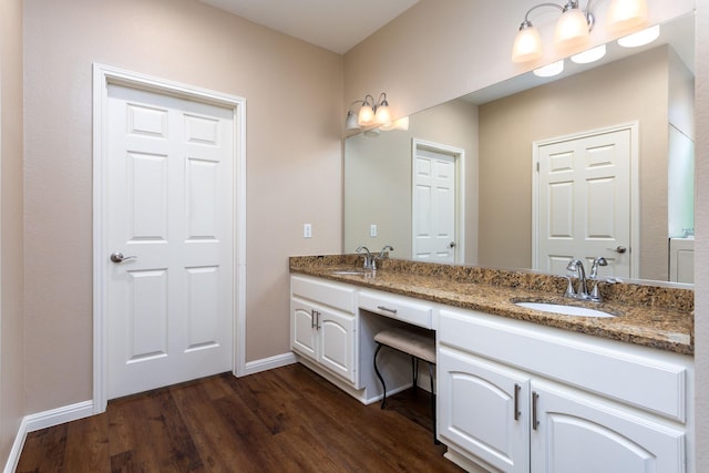 bathroom with hardwood / wood-style floors and vanity