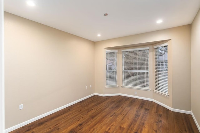 unfurnished room featuring hardwood / wood-style flooring