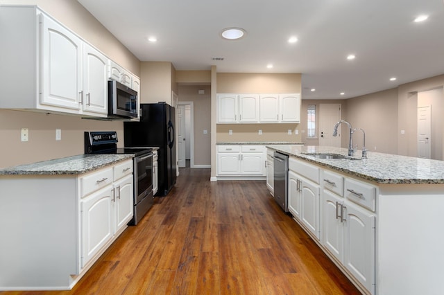 kitchen with sink, stainless steel appliances, a center island with sink, and white cabinetry