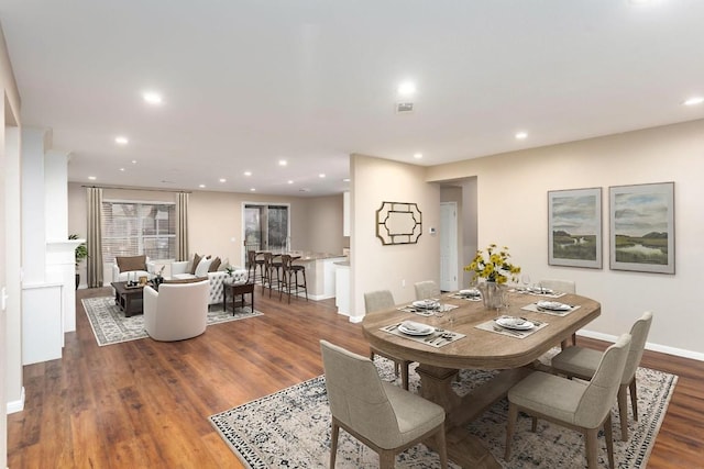 dining space featuring visible vents, recessed lighting, wood finished floors, and baseboards