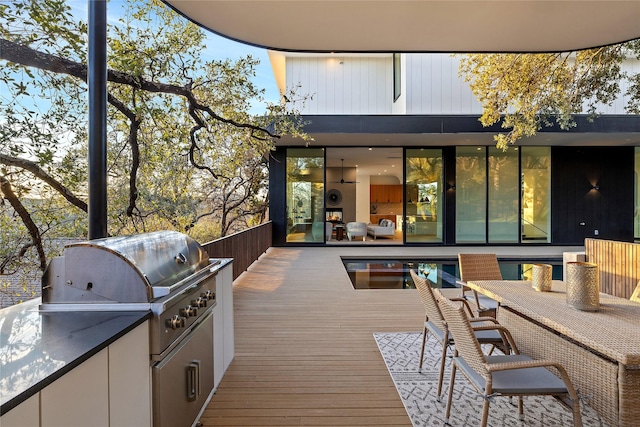 deck featuring a grill and an outdoor kitchen